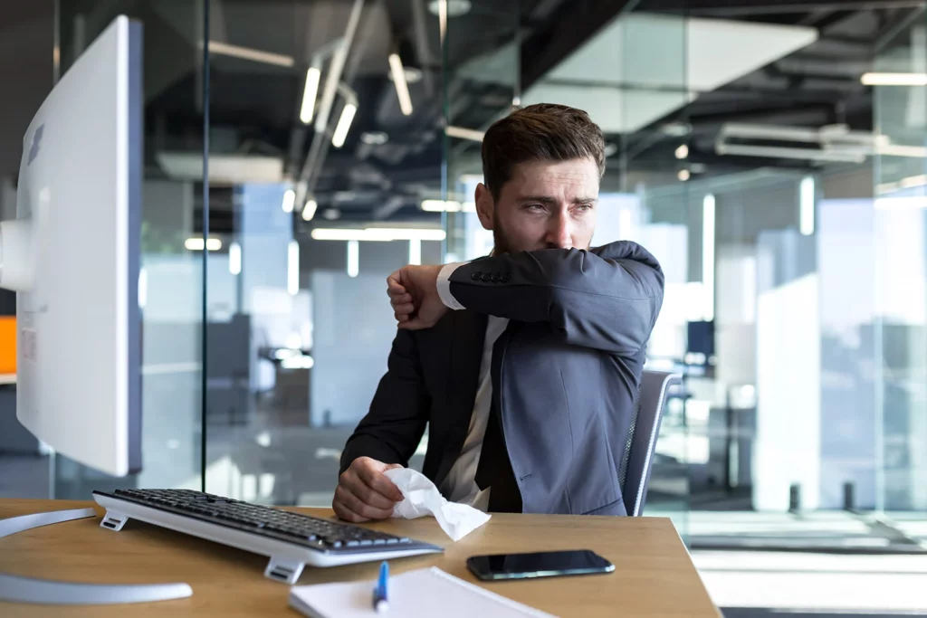 man suffering from effects of sick building syndrome